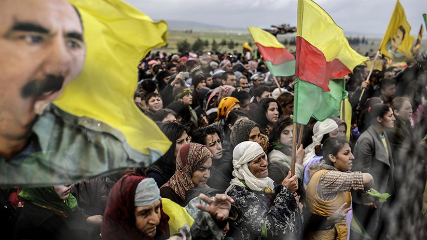 Syrian Kurdish people rally on Mistanur hill during a gathering to celebrate Newroz, the Kurdish New Year, in the Syrian Kurdish town of Kobane, also known as Ain al-Arab, on March 21, 2015. AFP PHOTO/YASIN AKGUL        (Photo credit should read YASIN AKGUL/AFP/Getty Images)