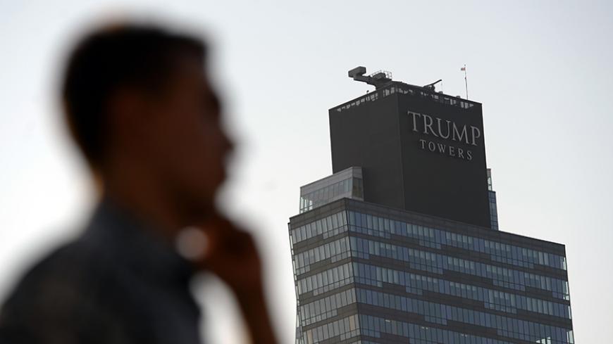 A man walks past the Trump Towers building in Istanbul on July 30, 2015. US billionaire Donald Trump handily leads all fellow Republicans in the 2016 presidential race, Hillary Clinton and other Democrats trump him in head-to-head matchups, a poll said July 30. AFP PHOTO/ OZAN KOSE        (Photo credit should read OZAN KOSE/AFP/Getty Images)