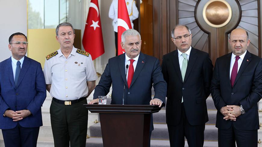 Turkish Prime Minister Binali Yildirim (C), flanked by Turkish Justice Minister Bekir Bozdag (L), Chief of the General Staff of the Turkish Armed Forces Hulusi Akar (2nd L), Turkish Interior Minister Efkan Ala (2nd R) and Turkish Defence Minister Fikri Isik (R), gives a press conference outside the Cankaya Palace in Ankara, on July 16, 2016.  
Turkish Prime Minister Binali Yildirim said on July 16, 2016 that 161 people were killed in the coup attempt against the government, with 2,839 soldiers now detained 