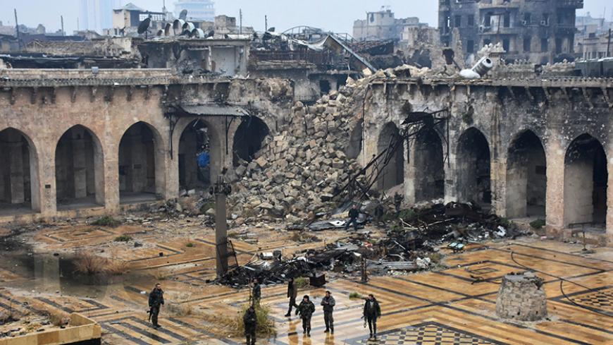TOPSHOT - A general view shows Syrian pro-government forces walking in the ancient Umayyad mosque in the old city of Aleppo on December 13, 2016, after they captured the area.
After weeks of heavy fighting, regime forces were poised to take full control of Aleppo, dealing the biggest blow to Syria's rebellion in more than five years of civil war.

 / AFP / George OURFALIAN        (Photo credit should read GEORGE OURFALIAN/AFP/Getty Images)