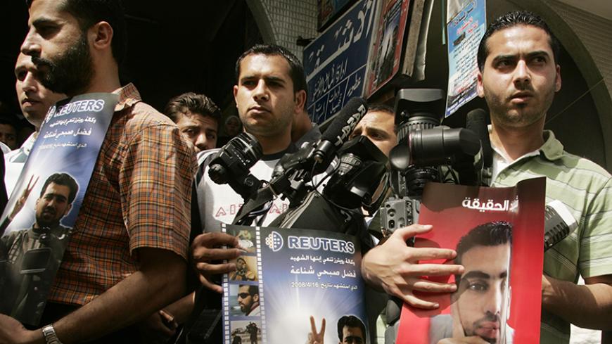 Palestinian journalists take part in a protest in front of the Reuters office in Gaza April 22, 208, against the killing of Reuters cameraman Fadel Shana. Shana, a 23-year-old Palestinian, was killed in the Gaza Strip on April 16, 2008 while covering events in the enclave for the international news agency. He had been filming an Israeli tank dug in about 1,000 yards (1 km) away. Gaza doctors said darts sprayed from a controversial missile used by Israel killed Shana. Israeli forces have not said whether one