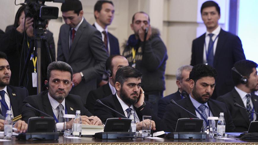 Mohammad Alloush (C), the head of the Syrian opposition delegation, attends Syria peace talks in Astana, Kazakhstan January 23, 2017. REUTERS/Mukhtar Kholdorbekov - RTSWWYO