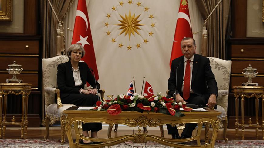 Turkish President Tayyip Erdogan and Britain's Prime Minister Theresa May are seen after their meeting at the Presidential Palace in Ankara, Turkey, January 28, 2017. REUTERS/Umit Bektas - RTSXRR4