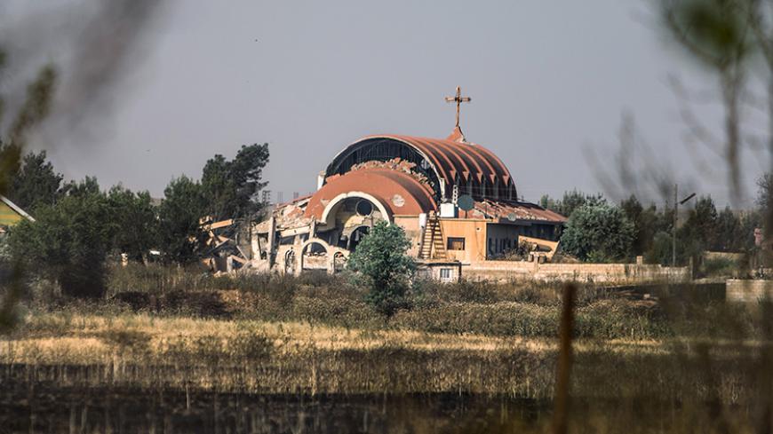 An Assyrian Church is seen damaged, due to what activists said was a bomb placed by Islamic State fighters, in tel Nusri, May 21, 2015. Picture taken May 21, 2015. REUTERS/Rodi Said - RTX1E3X3