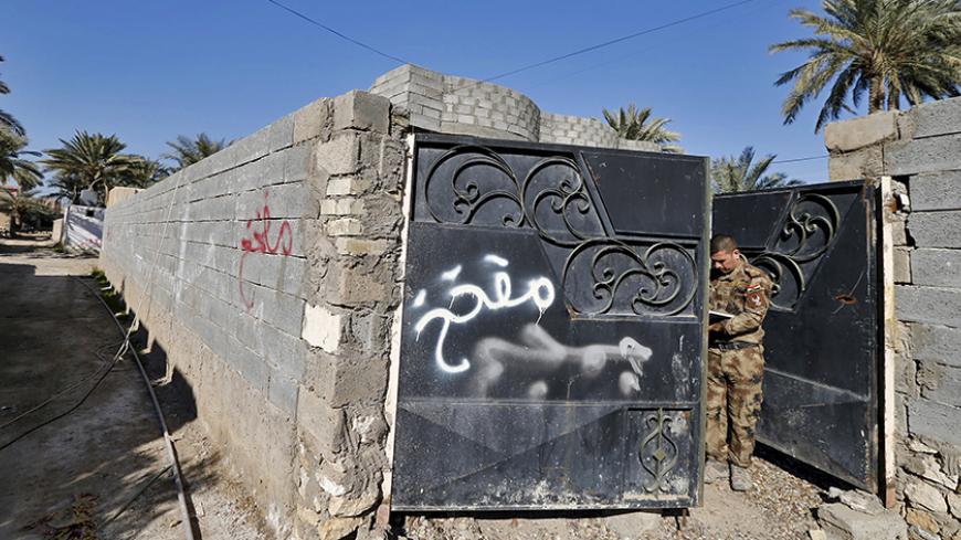 Graffiti warning on a house saying that the house is mined is seen in the city of Ramadi, January 16, 2016. Baghdad and Washington have touted Ramadi as the first major success for Iraq's U.S.-backed army since it collapsed in the face of Islamic State's lightning advance across the country's north and west in mid-2014. But the scorched-earth battlefield tactics used by both sides mean the prize is a shattered ruin. Picture taken January 16, 2016. REUTERS/Thaier Al-Sudani - RTX22WLQ