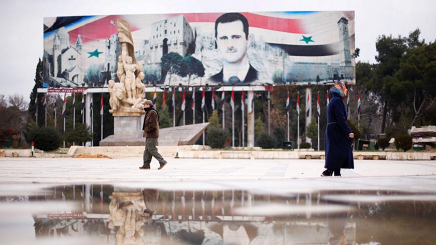 People walk past a billboard depicting Syria's President Bashar al-Assad at Saadallah al-Jabri Square, in the government controlled area of Aleppo, Syria December 17, 2016. REUTERS/Omar Sanadiki - RTX2VGTH