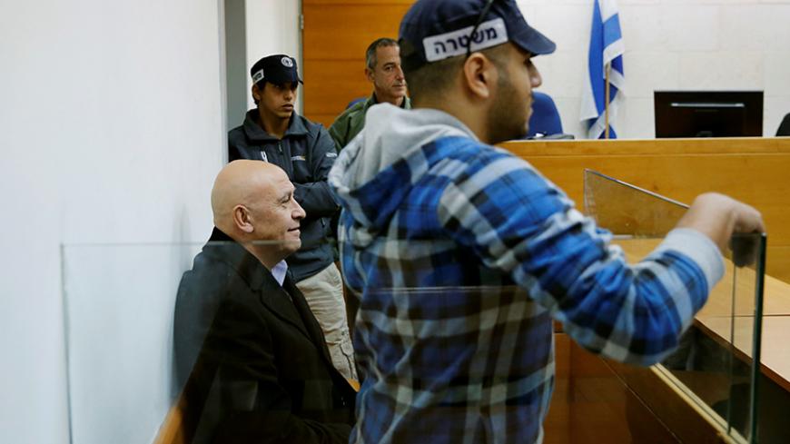 Israeli Knesset member Basel Ghattas sits at the Magistrates Court as police suspect Ghattas of smuggling mobile telephones into an Israeli jail for Palestinian convicts imprisoned for security offences against the state, in Rishon Lezion, Israel December 23, 2016. REUTERS/Amir Cohen - RTX2W8VS