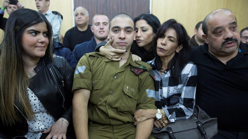 Israeli soldier Elor Azaria, who is charged with manslaughter by the Israeli military, sits to hear his verdict in a military court in Tel Aviv, Israel, January 4, 2017. REUTERS/Heidi Levine/Pool - RTX2XHOA