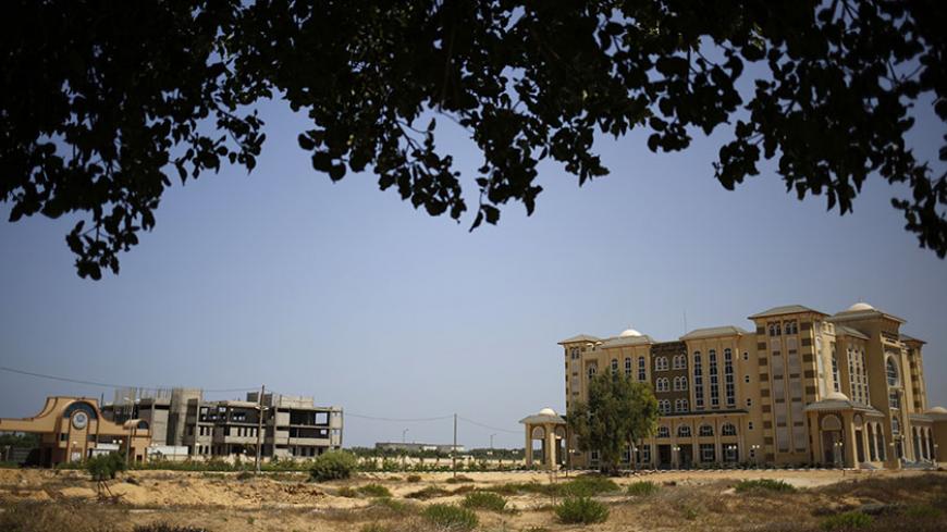 A general view taken on August 11, 2015 shows the Al-Azhar University, which was built on the former Jewish settlement of Netzarim, south of Gaza City, as Palestinians prepare to mark the tenth anniversary of the Israeli withdrawal from Gaza. Following the departure of the last Jewish settlers from Gaza in August 2005, the Israeli army demolished houses and dismantled its equipment before formally handing over the land to the Palestinian Authority. AFP PHOTO / MOHAMMED ABED        (Photo credit should read 