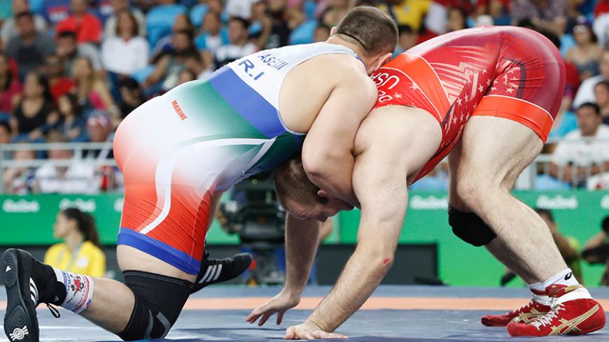 Iran's Komeil Nemat Ghasemi (blue) wrestles with USA's Tervel Ivaylov Dlagnev in their men's 125kg freestyle semi-final match on August 20, 2016, during the wrestling event of the Rio 2016 Olympic Games at the Carioca Arena 2 in Rio de Janeiro. / AFP / Jack GUEZ        (Photo credit should read JACK GUEZ/AFP/Getty Images)