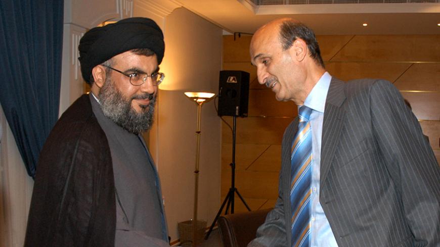 Lebanon's Hizbollah leader Sayyed Hassan Nasrallah (L) shakes hands with Maronite Christian leader Samir Geagea (R) during a meeting of Lebanese rival politicians at the parliament in downtown Beirut, May 16, 2006. REUTERS/Hassan Ibrahim /Pool - RTR1DF3M