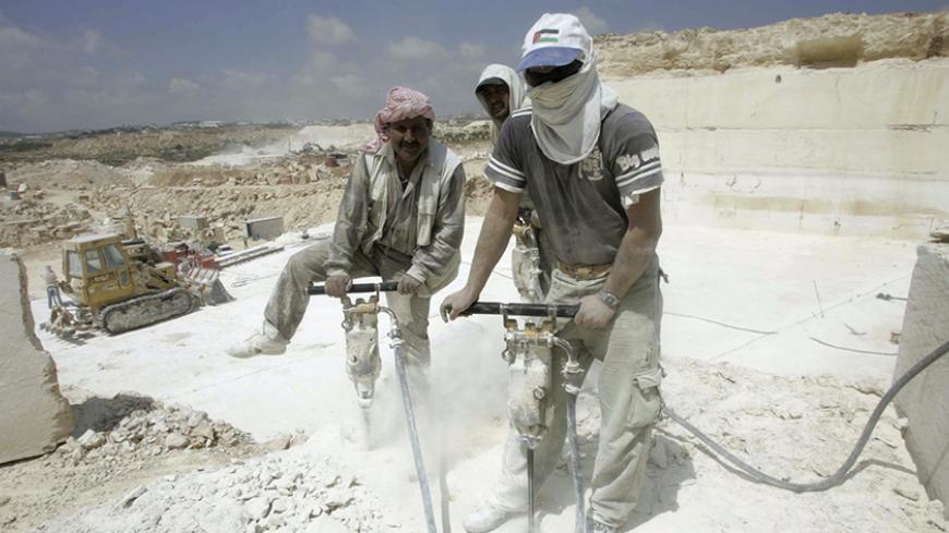 Palestinian labourers use jackhammers at a quarry in the West Bank village of Shioukh near Hebron April 10, 2007. Stone and marble factories and quarries, located mainly in the West Bank cities of Bethlehem and Hebron, are at the core of the Palestinian industrial sector. According to the Union of Stone and Marble Industry, the industry employs about 15,000 administrative, skilled and unskilled labourers. Picture taken April 10, 2007.  
REUTERS/Nayef Hashlamoun (WEST BANK) - RTR1P0SM