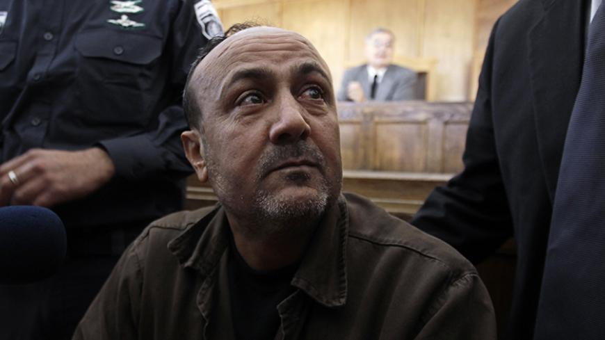 Jailed Fatah leader Marwan Barghouti attends a deliberation at Jerusalem Magistrate's court January 25, 2012. Convicted of murder for his role in attacks on Israelis, Barghouti was jailed for life by Israel in 2004.   REUTERS/Ammar Awad (JERUSALEM - Tags: POLITICS CRIME LAW) - RTR2WTIQ