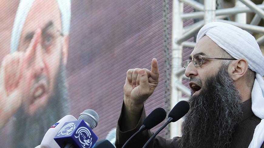 Sunni Muslim Salafist leader Ahmad al-Assir addresses his supporters during a protest against Hezbollah arms in Sidon, southern Lebanon, December 2, 2012. REUTERS/Ali Hashisho (LEBANON - Tags: POLITICS CIVIL UNREST) - RTR3B4SV