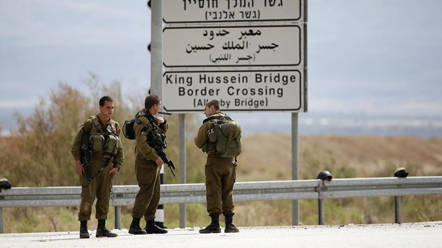 Israeli soldiers stand guard near the entrance to Allenby Bridge, a crossing point between Jordan and the occupied West Bank, near the West Bank town of Jericho March 10, 2014. Israeli soldiers shot and killed a Palestinian on Monday at the crossing point, Israeli and Palestinian security officials said. The Israeli military said the man had tried to seize a soldier's gun at the Allenby bridge, which spans the Jordan River, and that troops had then shot him. REUTERS/Ronen Zvulun (WEST BANK - Tags: POLITICS 