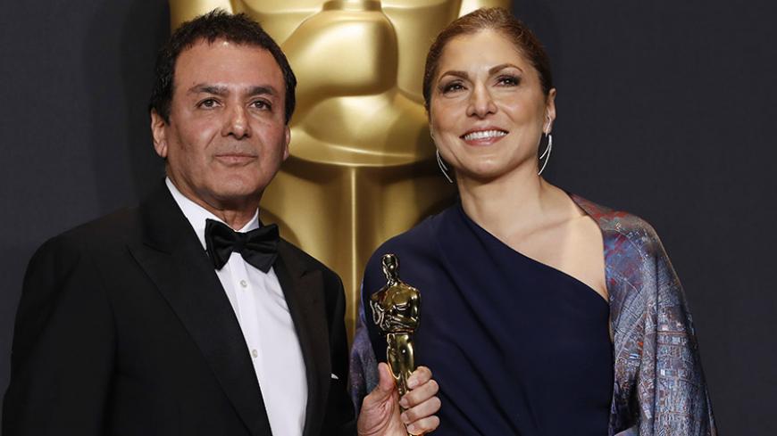 89th Academy Awards - Oscars Backstage - Hollywood, California, U.S. - 26/02/17 - Anousheh Ansari and Firouz Naderi pose with the Oscar they accepted on behalf of Asghar Farhadi, who won the Best Foreign Language Film for "The Salesman". REUTERS/Lucas Jackson - RTS10HRL