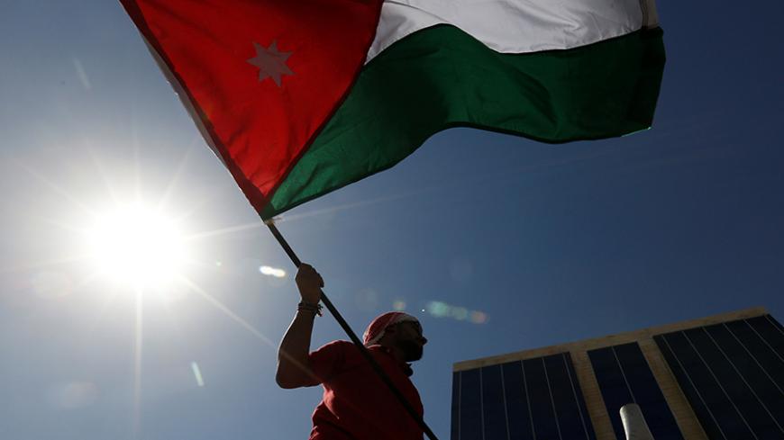 A Jordanian protester holds a Jordanian national flag, and chants slogans during a protest against a government agreement to import natural gas from Israel, in Amman, Jordan, October 7, 2016. REUTERS/Muhammad Hamed - RTSR7I4