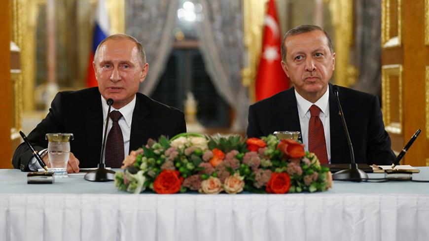 Russian President Vladimir Putin (L) talks during a joint news conference with his Turkish counterpart Tayyip Erdogan following their meeting in Istanbul, Turkey, October 10, 2016. REUTERS/Osman Orsal - RTSRNKN