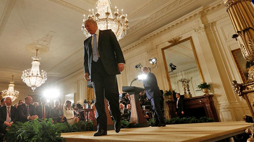 U.S. President Donald Trump walks from the lectern as Israeli Prime Minister Benjamin Netanyahu lingers behind at the conclusion of their joint news conference at the White House in Washington, U.S. February 15, 2017. REUTERS/Kevin Lamarque - RTSYU3B