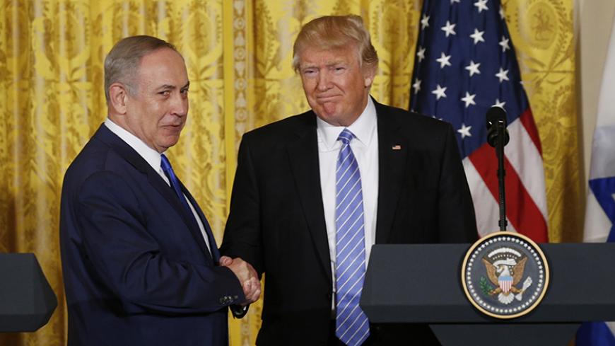 U.S. President Donald Trump (R) greets Israeli Prime Minister Benjamin Netanyahu after a joint news conference at the White House in Washington, U.S., February 15, 2017.   REUTERS/Kevin Lamarque  - RTSYU9T