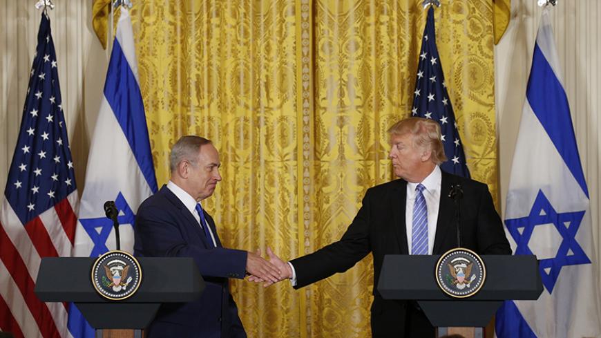 U.S. President Donald Trump (R) greets Israeli Prime Minister Benjamin Netanyahu after a joint news conference at the White House in Washington, U.S., February 15, 2017.   REUTERS/Kevin Lamarque  - RTSYUDS