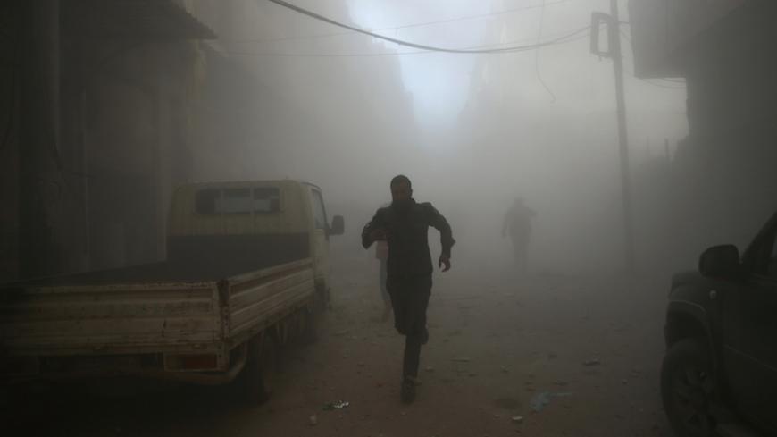 Men run at a site hit by airstrikes in the rebel held besieged Douma neighbourhood of Damascus, Syria February 19, 2017. REUTERS/Bassam Khabieh - RTSZDP3