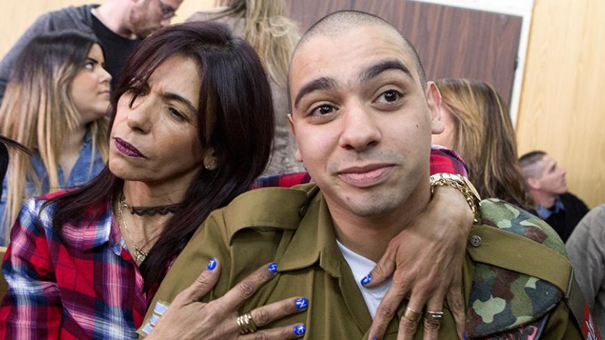 Israeli soldier Elor Azaria is embraced by his mother at the start of is sentencing hearing at a military court in Tel Aviv, Israel February 21, 2017. REUTERS/Jim Hollander/Pool      TPX IMAGES OF THE DAY - RTSZLCK
