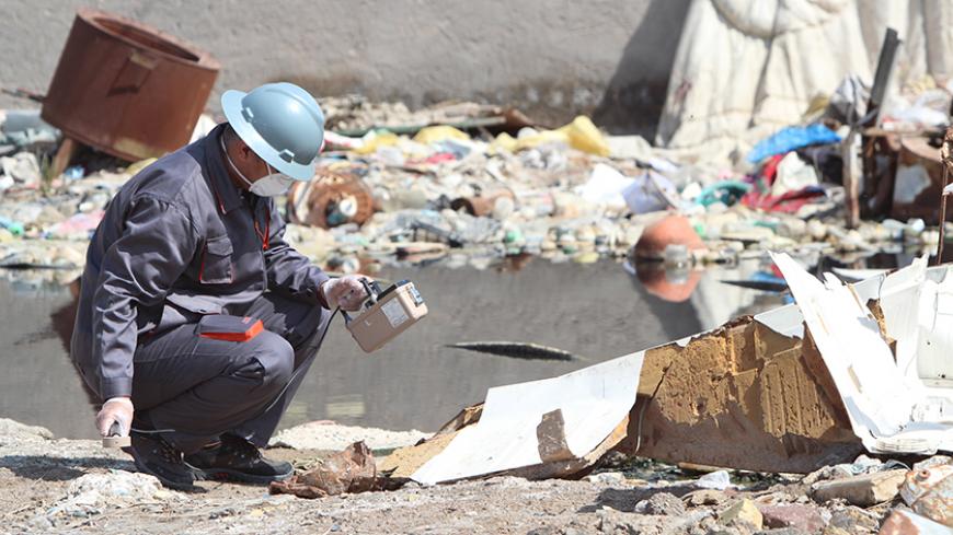 A member of a counter-radiation team uses a Geiger counter to search for missing radioactive material in Basra, Iraq, February 21, 2016. Radioactive material that went missing in Iraq has been found dumped near a petrol station in the southern town of Zubair, officials said on Sunday, ending speculation it could be acquired by Islamic State and used as a weapon. The officials told Reuters the material, stored in a protective case the size of a laptop computer, was undamaged and there were no concerns about 