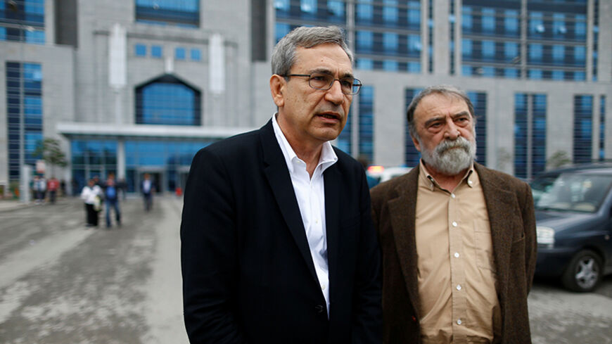 Turkish writer, columnist and academic Murat Belge (R) and Turkish author Orhan Pamuk leave Kartal Justice Palace after Belge appeared in court on charges of insulting Turkish President Tayyip Erdogan in Istanbul, Turkey May 3, 2016. REUTERS/Osman Orsal - RTX2CLCD