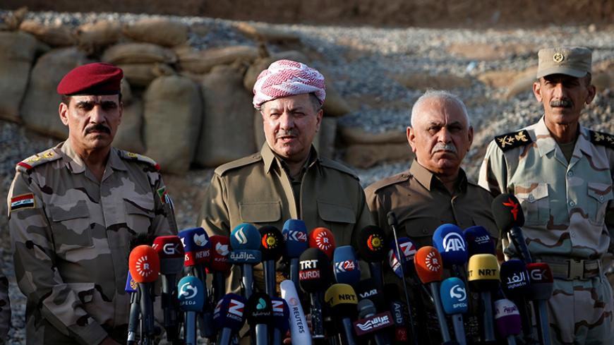 Iraq's Kurdistan region's President Massoud Barzani (C) speaks during a news conference on the outskirts of Mosul, Iraq, October 17, 2016. REUTERS/Azad Lashkari - RTX2P71L