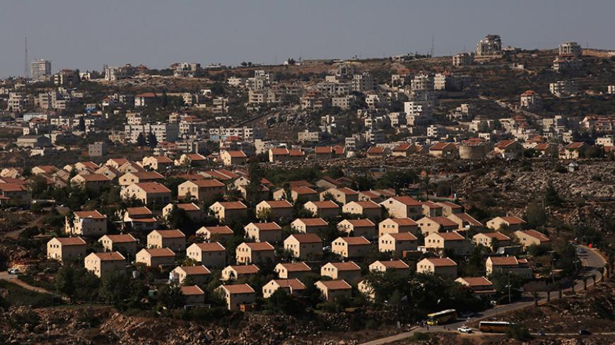 The West Bank Jewish settlement of Ofra is photographed as seen from the Jewish settler outpost of Amona in the West Bank, during an event organised to show support for Amona which was built without Israeli state authorisation and which Israel's high court ruled must be evacuated and demolished by the end of the year as it is built on privately-owned Palestinian land, October 20, 2016. The Palestinian village of Silwad is seen in the background. REUTERS/Ronen Zvulun - RTX2POW2