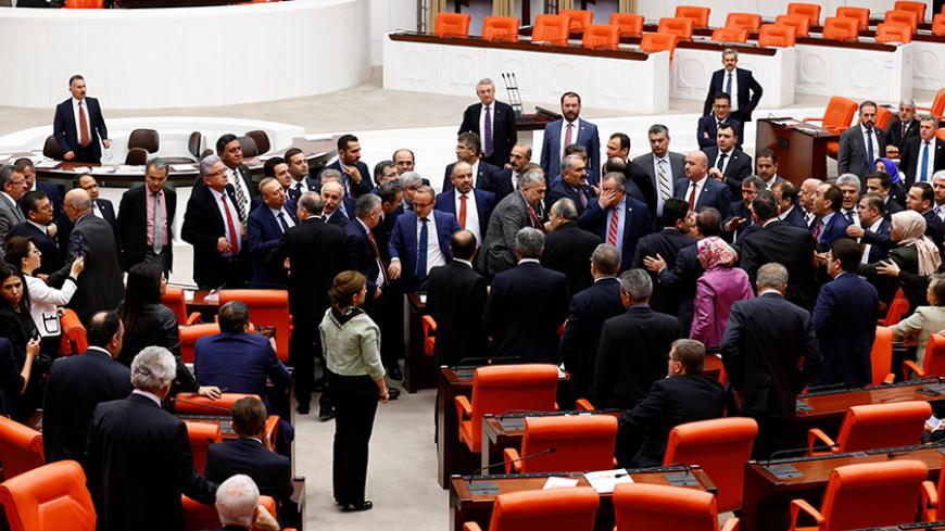 Lawmakers from ruling AK Party and the main opposition CHP scuffle during a debate on the proposed constitutional changes at the Turkish Parliament in Ankara, Turkey, January 12, 2017. REUTERS/Umit Bektas - RTX2YN0M