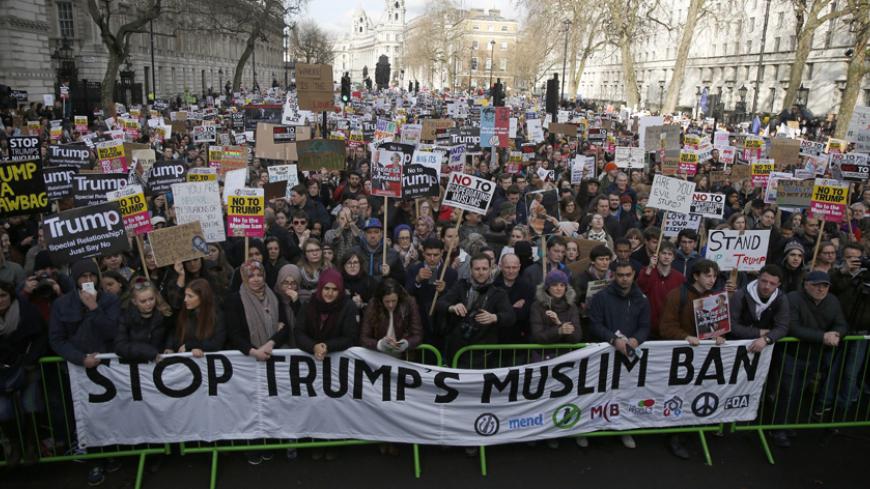 Demonstrators hold placards outside Downing Street during a march against U.S. President Donald Trump and his temporary ban on refugees and nationals from seven Muslim-majority countries from entering the United States, in London, Britain, February 4, 2017. REUTERS/Neil Hall - RTX2ZLR6