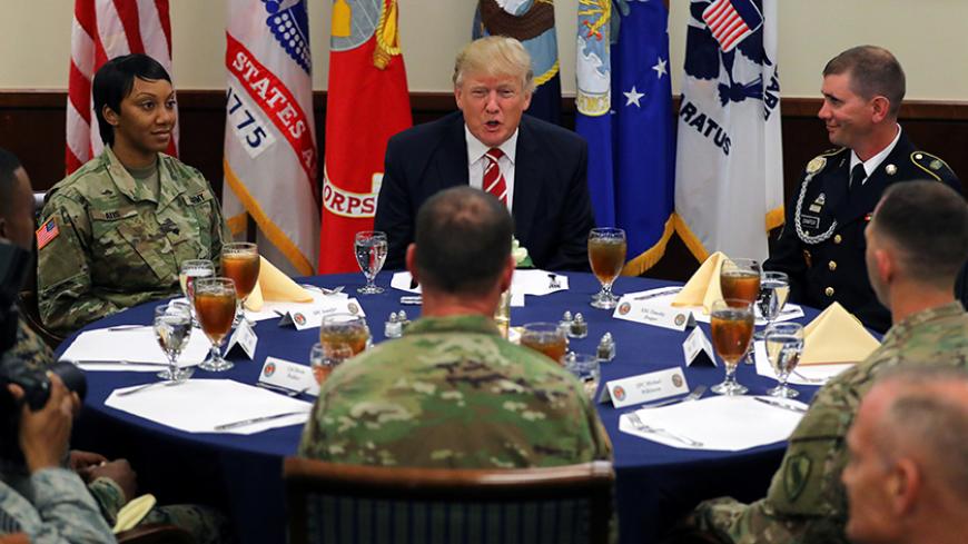 U.S. President Donald Trump attends a lunch with members of the U.S. military during a visit at the U.S. Central Command (CENTCOM) and Special Operations Command (SOCOM) headquarters in Tampa, Florida, U.S., February 6, 2017. REUTERS/Carlos Barria     TPX IMAGES OF THE DAY - RTX2ZWGG