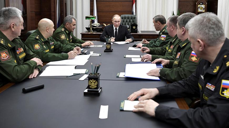 Russian President Vladimir Putin, Defence Minister Sergei Shoigu and chief of Russia's General Staff Valery Gerasimov attend a meeting with top military officials at the Defence Ministry in Moscow, Russia December 22, 2016. Sputnik/Kremlin/Alexei Nikolskyi via REUTERS ATTENTION EDITORS - THIS IMAGE WAS PROVIDED BY A THIRD PARTY. EDITORIAL USE ONLY. - RTX2W5YN