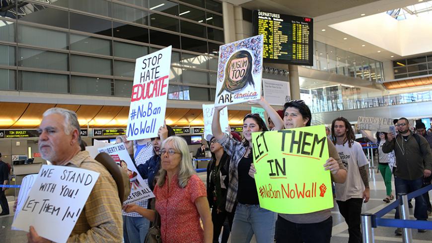 People gather to protest against U.S. President Donald Trump's executive order travel ban at Los Angeles International Airport (LAX), California, U.S. January 31, 2017.  REUTERS/Monica Almeida - RTX2Z2ZB