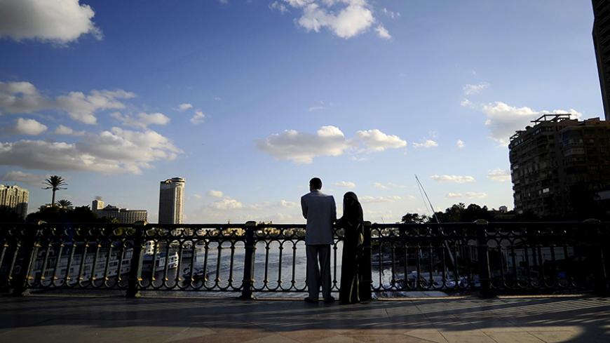 An Egyptian couple stands on a bridge overlooking the Nile River in downtown Cairo on December 25, 2011. AFP PHOTO / Filippo MONTEFORTE (Photo credit should read FILIPPO MONTEFORTE/AFP/Getty Images)