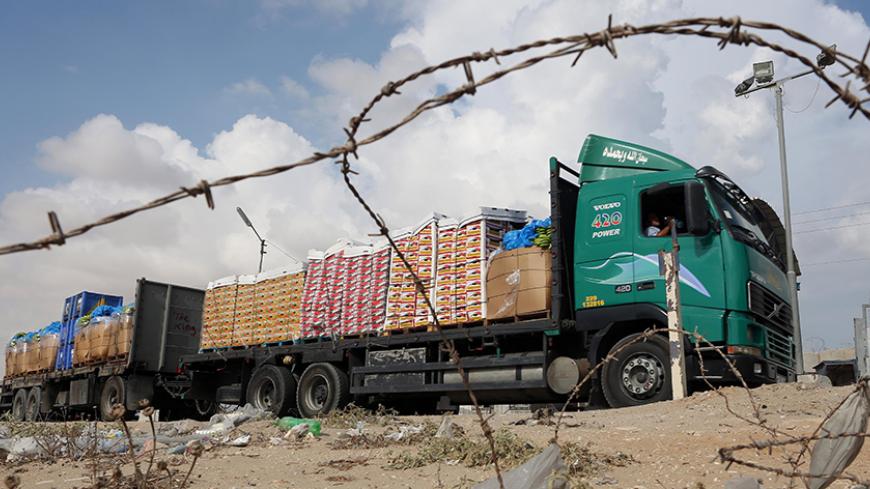A truck loaded with goods enters the Gaza Strip from Israel through the Kerem Shalom crossing on October 12, 2014, in Rafah in southern Gaza. Some 50 countries are attending a Gaza Donor Conference in Egypt, with Palestinians hoping for $4 billion in global pledges, despite wariness from donors that without a full peace treaty with Israel they may just be pouring money down the drain. AFP PHOTO / SAID KHATIB        (Photo credit should read SAID KHATIB/AFP/Getty Images)
