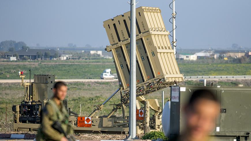 Israeli soliders patrol near an Iron Dome defence system, designed to intercept and destroy incoming short-range rockets and artillery shells, in the Israeli-annexed Golan Heights, on January 20, 2015, two days after an Israeli air strike killed six Hezbollah members in the Syrian-controlled side of the Golan Heights. The strike on Syria killed an Iranian general, Tehran confirmed on January 19, as thousands of supporters of Lebanon's Hezbollah gathered to bury one of the six fighters killed in the same rai