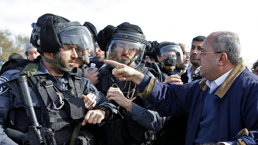 TOPSHOT - Arab-Israeli Knesset (Israel's Parliament) members, Ahmad al-Tibi (R) confronts an Israeli policeman during clashes with Bedouin protesters in the village of Umm al-Hiran, which is not recognized by the Israeli government, near the southern city of Beersheba, in the Negev desert,  on January 18, 2017.
An Israeli policeman was killed while taking part in an operation to demolish homes in the Bedouin village, with authorities claiming he was targeted in a car-ramming attack. The driver was earlier r