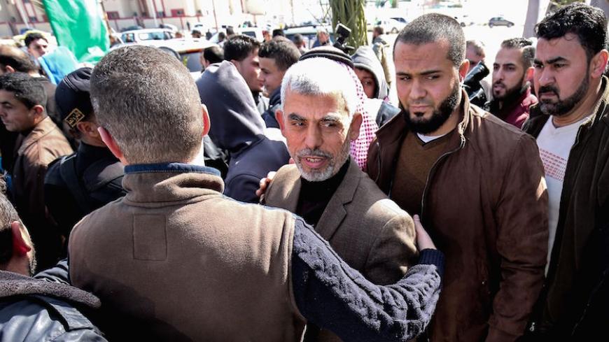 Yahya Sinwar (C), the new leader of Hamas in the Gaza Strip, arrives for the opening of a new mosque in Rafah town in the southern Gaza Strip on February 24, 2017. / AFP / SAID KHATIB        (Photo credit should read SAID KHATIB/AFP/Getty Images)