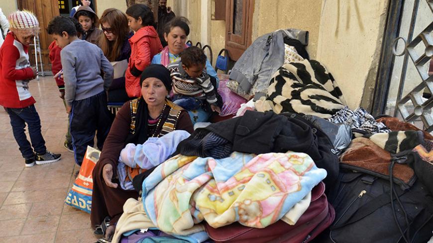 Egyptian Coptic Christians sit in the courtyard of the Evangelical Church in the Suez Canal city of Ismailiya on February 24, 2017, upon arriving to take refuge from Islamic State (IS) group jihadists.
Dozens of Coptic Christians have left Egypt's Sinai Peninsula after a string of jihadist attacks killed three Christians in the restive province, church officials said. / AFP / STRINGER        (Photo credit should read STRINGER/AFP/Getty Images)