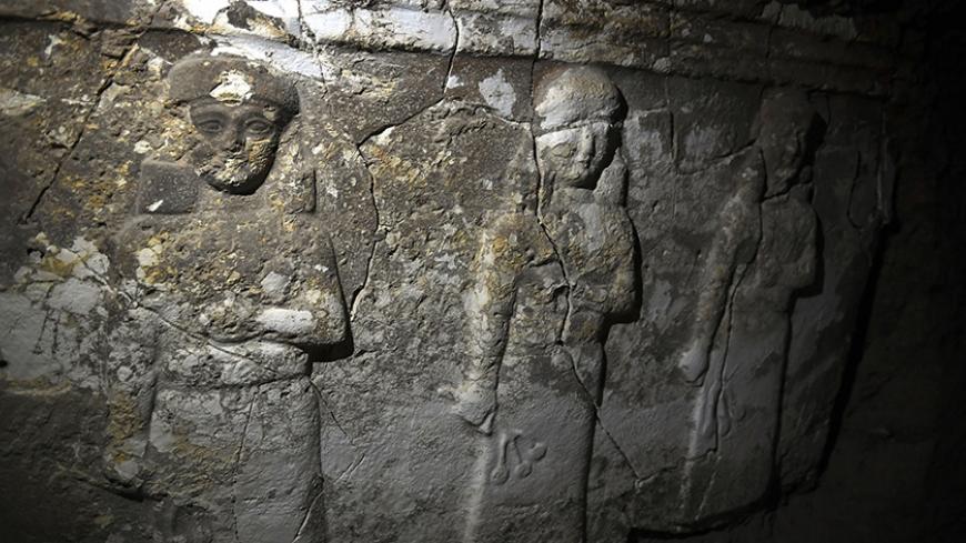 Archeological findings are pictured inside an underground tunnel in east Mosul on March 6, 2017. 
Two winged bulls dating from the Assyrians empire were found in a labyrinth of narrow underground tunnels dug by the Islamic State group in east Mosul. The impressive maze of tunnels dug by the jihadists to carry out archaeological excavations is located in the heart of the hill that houses the tomb of the Prophet Jonah (Nabi Younes). / AFP PHOTO / ARIS MESSINIS        (Photo credit should read ARIS MESSINIS/AF