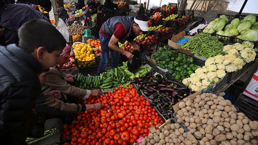 Iraqis buy vegetables at a market in the Hamam al-Alil area, south of Mosul, on March 11, 2017, following it's liberation by Iraqi forces during an offensive to retake the western parts of Mosul from the jihadists. / AFP PHOTO / AHMAD AL-RUBAYE        (Photo credit should read AHMAD AL-RUBAYE/AFP/Getty Images)