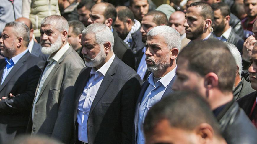 EDITORS NOTE: Graphic content / Yahya Sinwar (C-R), the new leader of Hamas in the Gaza Strip and senior political leaders of the Islamist movement, Ismail Haniyeh (C-L) and Rawhi Moshtaha (L-2) attend the funeral of Hamas official, Mazen Faqha in Gaza city on March 25, 2017.
Gunmen in the Gaza Strip had shot dead the Hamas official on March 24, 2017, according to Iyad al-Bozum, an interior ministry spokesman in the Hamas-ruled Gaza Strip. Faqha had been released by Israel six years earlier in the 2011 pris