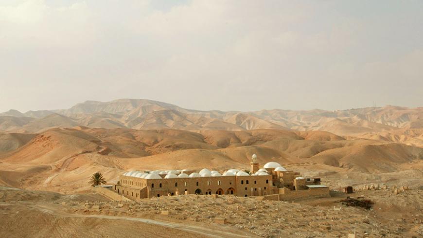 A general view of the the holy mosque of Nabi Musa where the tomb of Prophet Moses is placed, surround by the desert near the West Bank town of Jericho 23 November 2002. The tomb is considered holy because it houses the grave of the prophet Moses according to local tradition. Moses is recognized by Moslems as one of the great prophets of Islam. The main body of the present shrine, the mosque, the minaret, and some of the rooms, were built in AD 1269 during the reign of the Mamluk Sultan, Al Dhaher Baybars. 