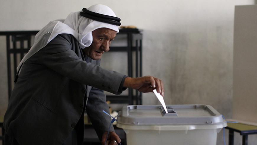 A Palestinian man casts his ballot for municipal elections at a polling station in the West Bank village of Shiyoukh, north of Hebron October 20, 2012. Palestinians voted in local elections in the Israel-occupied West Bank on Saturday, their first vote for six years and one with little choice, out of step with democratic revolutions elsewhere in the Arab world. REUTERS/Ammar Awad (WEST BANK - Tags: ELECTIONS POLITICS) - RTR39D2U