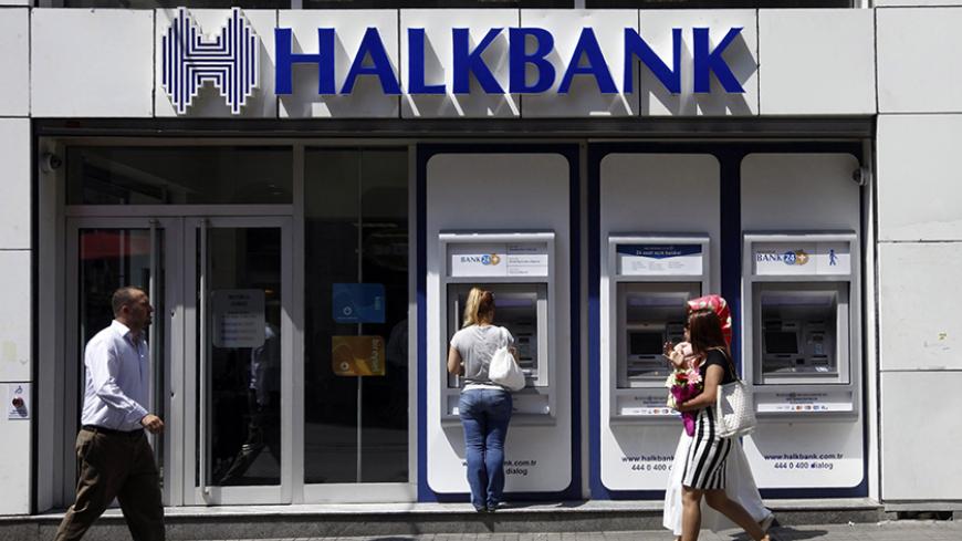 A customer (C) uses an automated teller machine at a branch of Halkbank in Istanbul August 15, 2014. Turkey's state-run lender Halkbank said on Friday it has offer to buy a 76.76 percent stake in Serbian lender Cacanska Banka for an undisclosed sum. Halkbank offered no further details on the potential acquisition in a statement to the Istanbul stock exchange. REUTERS/Osman Orsal (TURKEY - Tags: BUSINESS) - RTR42JV5