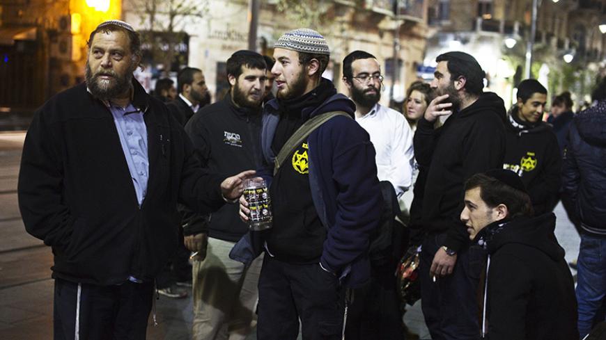 Benzion Gopshtein (L), leader of the far-right Israeli group Lehava, gathers with fellow activists in Jerusalem December 25, 2014.  A far-right Israeli group that agitates against Arabs in the name of religion and national security is forcing the Jewish state into a legal and political balancing act as it tries to contain sectarian violence. The authorities are under pressure to deal with anyone encouraging Jewish retaliation against Israeli Arabs and Palestinians. Efforts to tackle Lehava, however, may be 