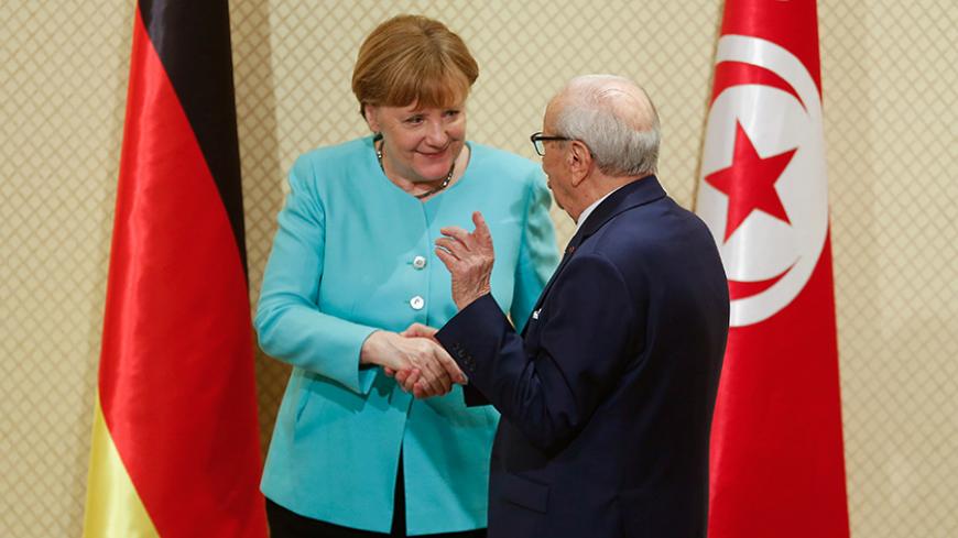 Tunisia's President Beji Caid Essebsi shakes hands with German Chancellor Angela Merkel at Carthage Palace in Tunis, Tunisia, March 3, 2017. REUTERS/Zoubeir Souissi - RTS11C5L